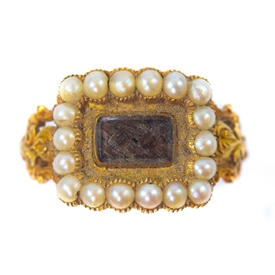 Lot 215 - A Georgian high purity gold seed pearl set mourning ring with glazed hair panel.