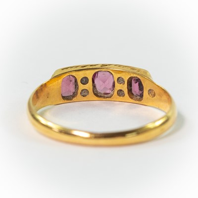 Lot 113 - An early 20th century 15ct garnet and seed pearl set ring.
