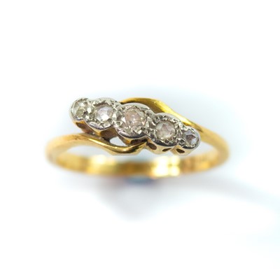 Lot 176 - An 18ct and platinum set diamond five stone crossover ring.