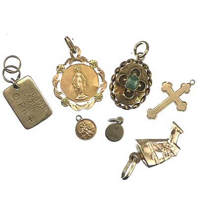 Lot 106 - A Victorian gold small oval pendant and six gold charms.