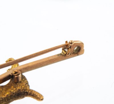 Lot 171 - A 9ct gold bar brooch applied with an Airedale Terrier dog.