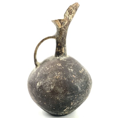 Lot 881 - An Anatolian pottery beak spout globular jug,...