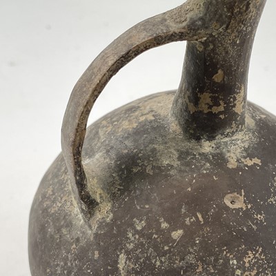 Lot 881 - An Anatolian pottery beak spout globular jug,...