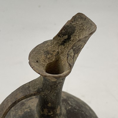 Lot 881 - An Anatolian pottery beak spout globular jug,...