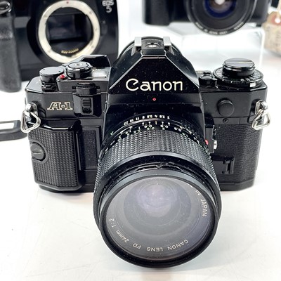 Lot 148 - A Canon EOS 1000F SLR camera serial number...