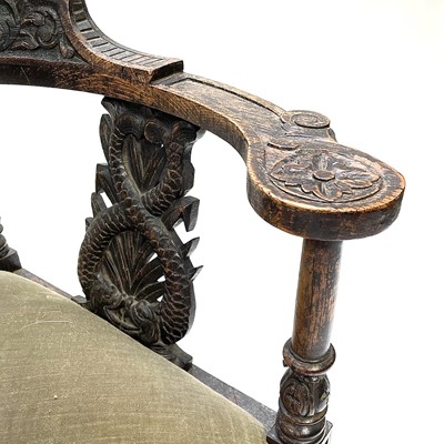 Lot 21 - A Victorian carved oak corner armchair.