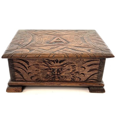 Lot 24 - A carved oak work box, circa 1900-1920