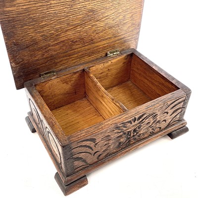 Lot 24 - A carved oak work box, circa 1900-1920