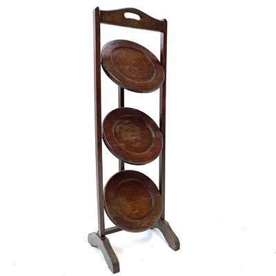 Lot 57 - An oak three-tier folding cake stand, early 20th century.