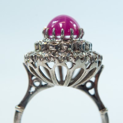 Lot 69 - A white gold star ruby and diamond set cluster ring.