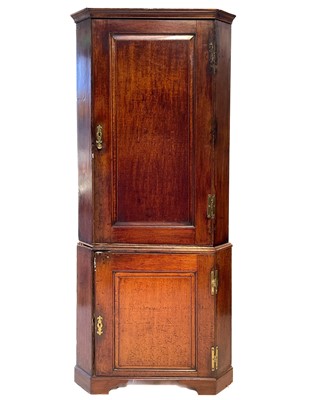 Lot 43 - A George III oak standing corner cupboard.