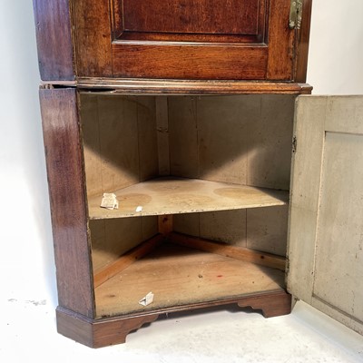 Lot 43 - A George III oak standing corner cupboard.