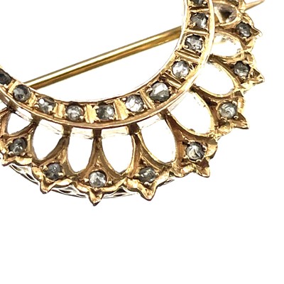 Lot 21 - A Victorian rose gold diamond set crescent brooch.