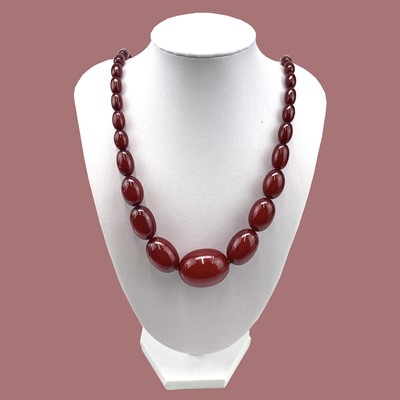 Lot 237 - Cherry Amber Bakelite, with oval graduated beads.