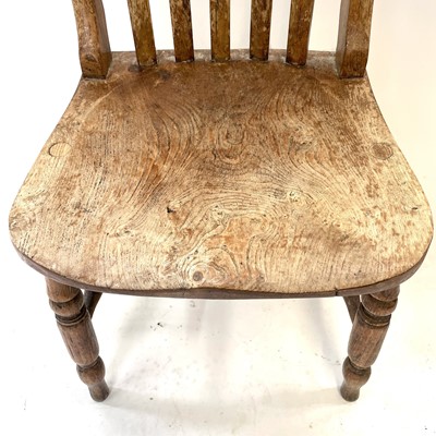 Lot 64 - A Victorian beech and elm lathe back kitchen chair.