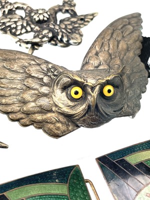 Lot 242 - A collection of belt buckles, including a silver plated owl buckle with glass inset eyes.