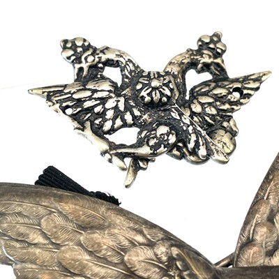 Lot 242 - A collection of belt buckles, including a silver plated owl buckle with glass inset eyes.