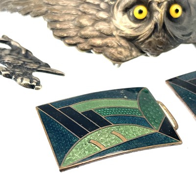 Lot 242 - A collection of belt buckles, including a silver plated owl buckle with glass inset eyes.