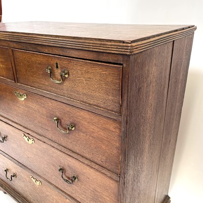 Lot 75 - A George III oak chest of drawers.