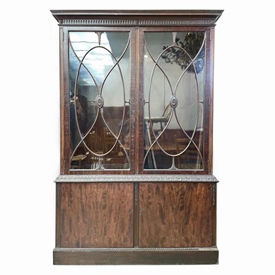 Lot 1882 - A George III style mahogany bookcase cabinet,...