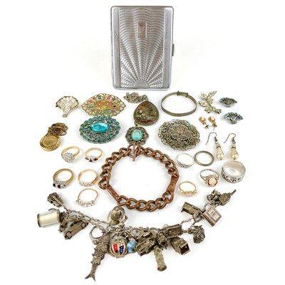 Lot 394 - A silver horse shoe charm bracelet applied with many charms, 92g.