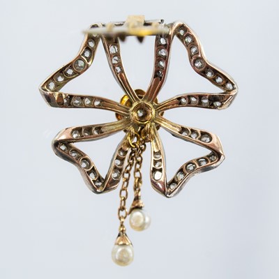 Lot 22 - A Belle Epoque diamond and seed pearl ribbon bow brooch