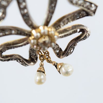 Lot 22 - A Belle Epoque diamond and seed pearl ribbon bow brooch