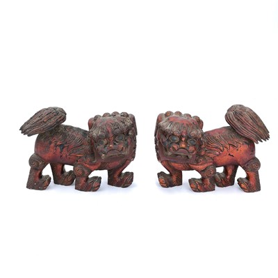 Lot 252 - A pair of Chinese wood carved and lacquered dogs of fo.