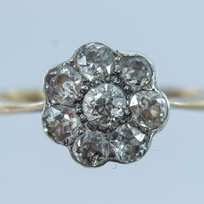 Lot 63 - An 18ct gold and platinum diamond eight stone daisy ring.
