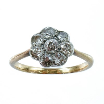 Lot 63 - An 18ct gold and platinum diamond eight stone daisy ring.