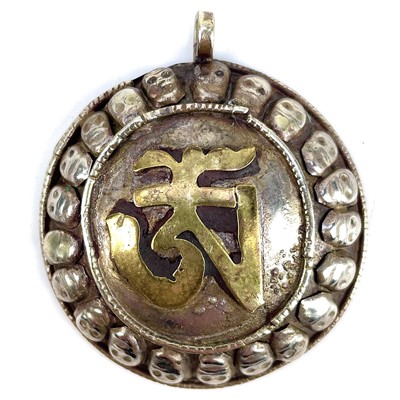 Lot 162 - A white metal Buddhistic Tibetan pendant.