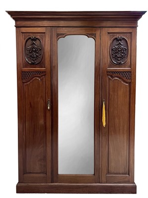 Lot 1858 - A late Victorian walnut triple wardrobe, with...