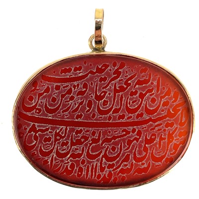 Lot 1027 - An Arabic script rose gold mounted carnelian oval pendant