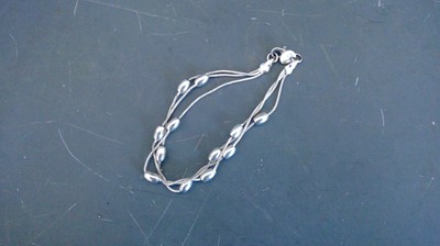 Lot 68 - A silver 925 three strand bracelet. 13.9g