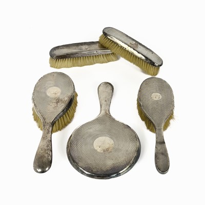 Lot 82 - Four silver dressing table brushes and a hand mirror
