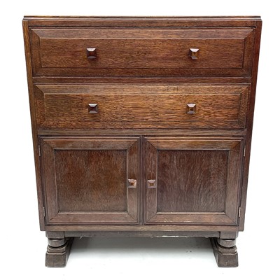 Lot 1811 - An Arts and Crafts oak bedroom cabinet, circa...