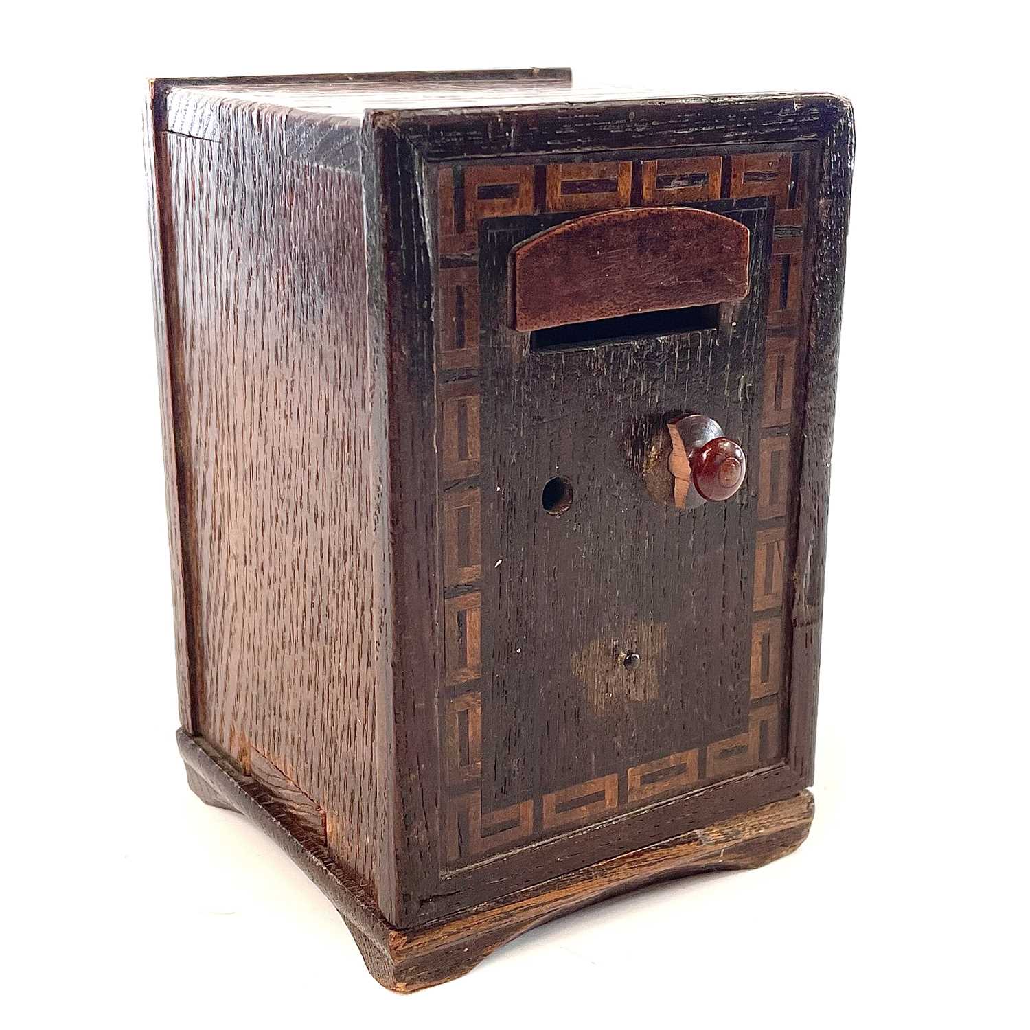 Lot 129 - An oak money box in the form of a safe, 19th