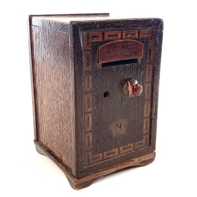 Lot 129 - An oak money box in the form of a safe, 19th century