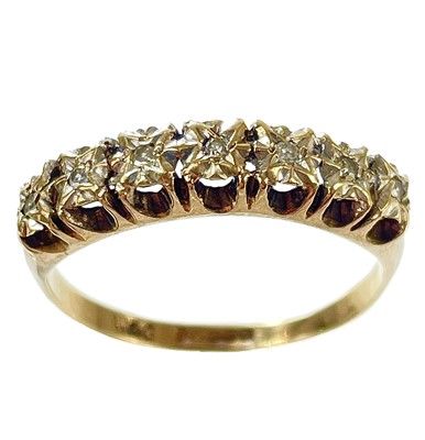 Lot 355 - A 9ct gold diamond set seven stone ring.