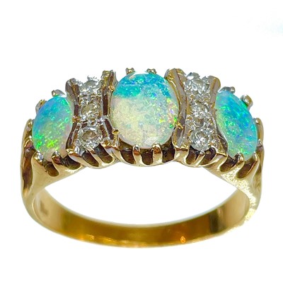 Lot 349 - An 18ct opal and diamond nine stone ring.