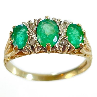 Lot 342 - A 9ct diamond and emerald seven stone ring.