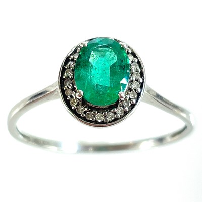 Lot 350 - A 9ct white gold emerald and diamond cluster ring.