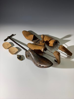 Lot 212 - An antique shoe stretcher, a pair of wooden...