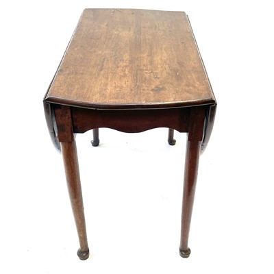 Lot 144 - A Georgian oak drop leaf dining table.