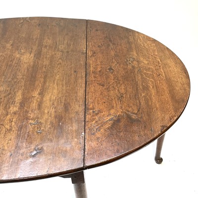 Lot 144 - A Georgian oak drop leaf dining table.