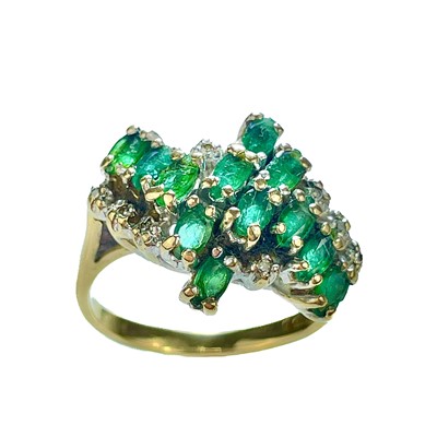 Lot 228 - A modern 9ct gold diamond and emerald cluster ring.