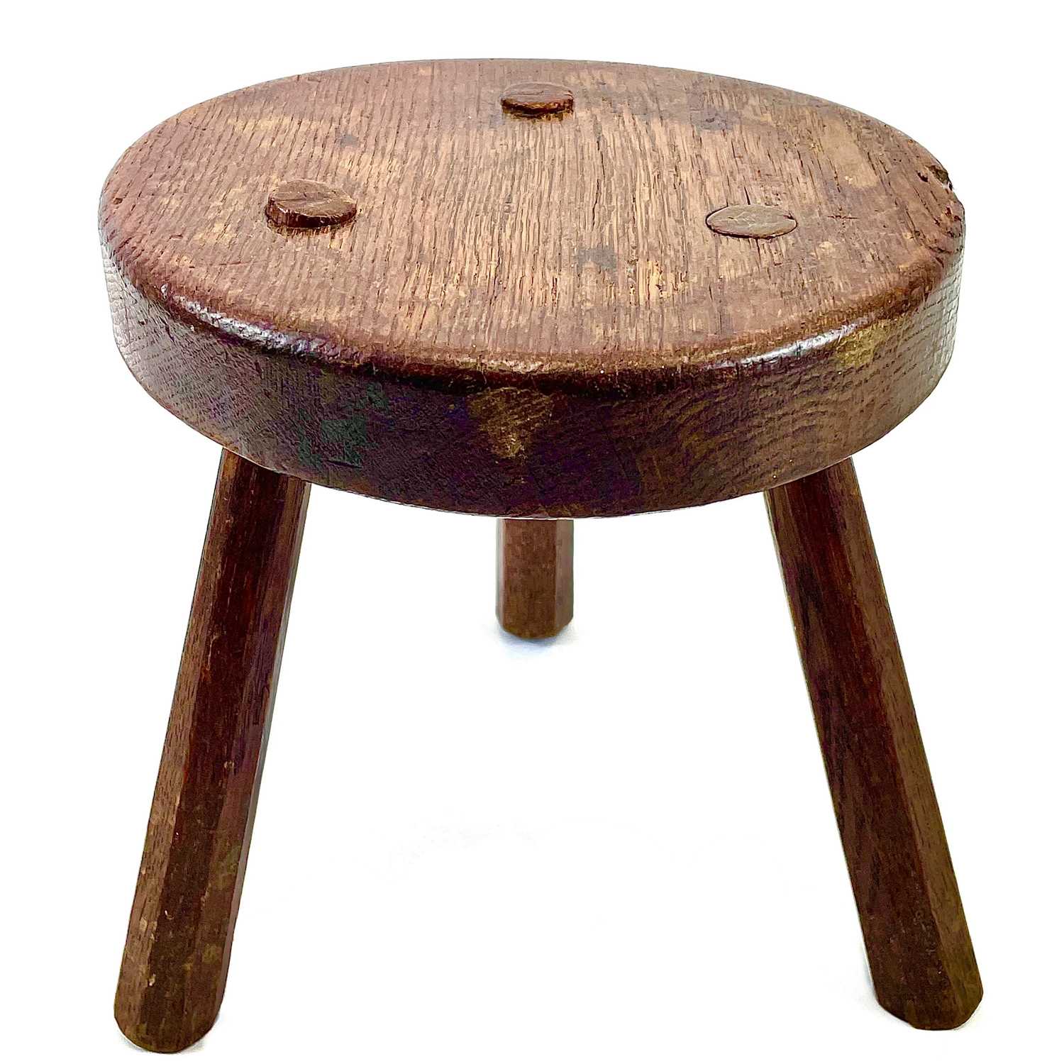 Lot 216 - An oak milking stool.