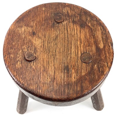 Lot 216 - An oak milking stool.