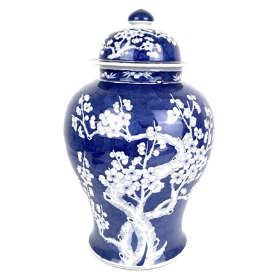 Lot 135 - A Chinese porcelain blue and white prunus pattern baluster vase and cover, 20th century