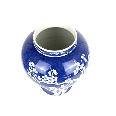 Lot 135 - A Chinese porcelain blue and white prunus pattern baluster vase and cover, 20th century